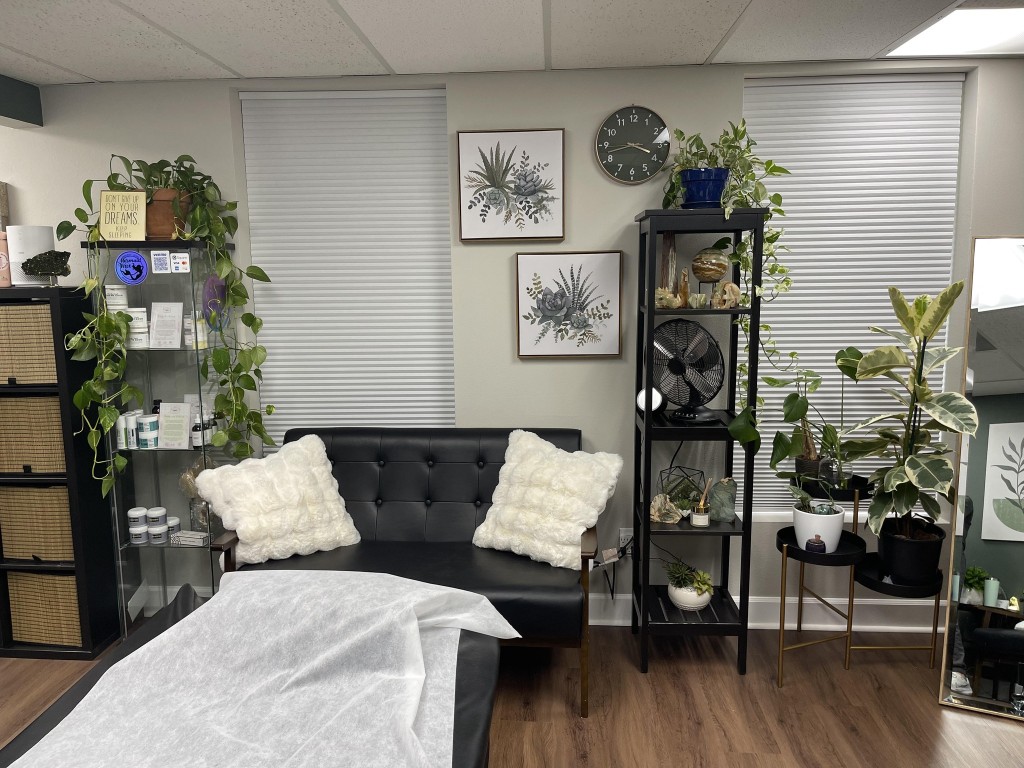 Northwest Wax treatment room with seating area, plants, and product display inside Cedar + Sage Studios